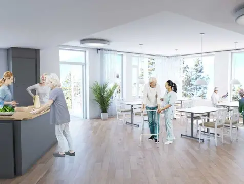 Illustration visar hur det tänkta köket kommer att se ut. Vid en köksö samtalar tre kvinnor. En annan kvinna hjälper en äldre man med gåstol.
